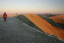 205-0601 Walker Approaching the Summit of Helvellyn at Dawn. Lake District, Cumbria